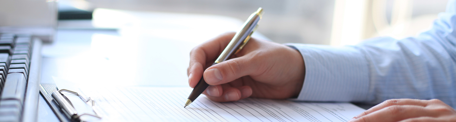 A member of The Sanibel Captiva Trust Company management team writing on paper