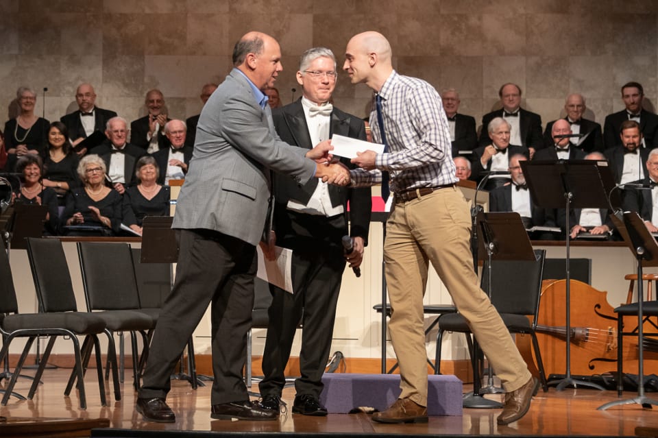 Steve Greenstein of Sanibel Captiva Trust congratulates Dr. Zack Stanton on winning their inaugural choral composition prize