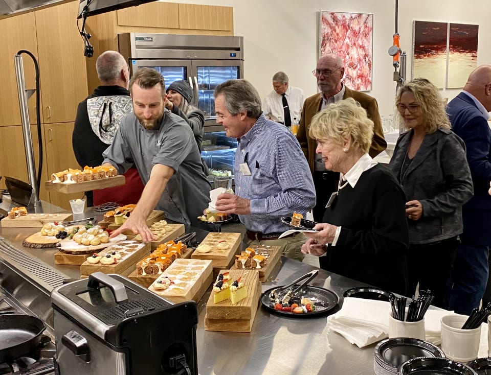 Chef Craig Tinling refreshes dessert trays for guests at the Tampa Bay Trust Company's Dunedin event