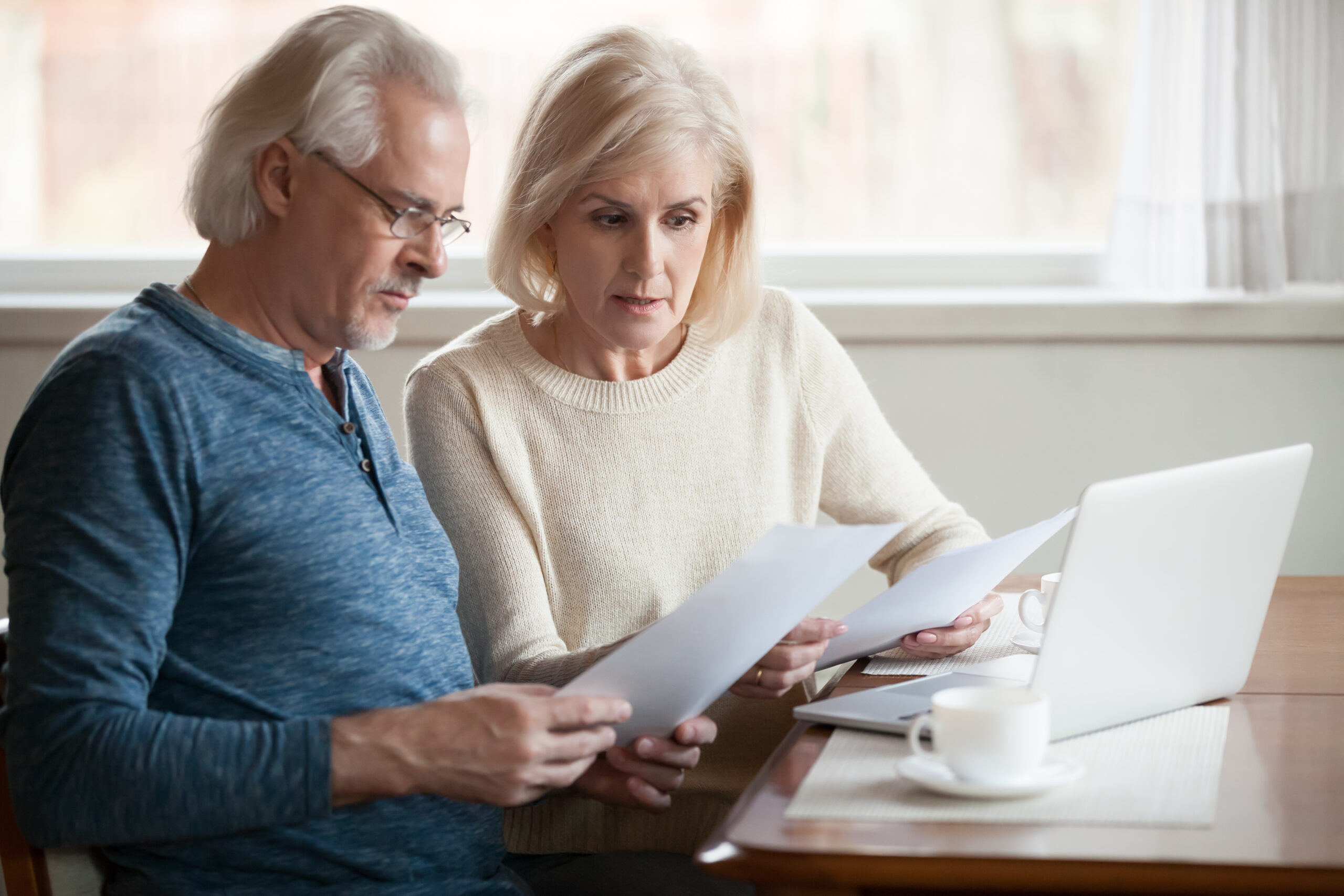 Older couple sitting at computer working on retirement planning