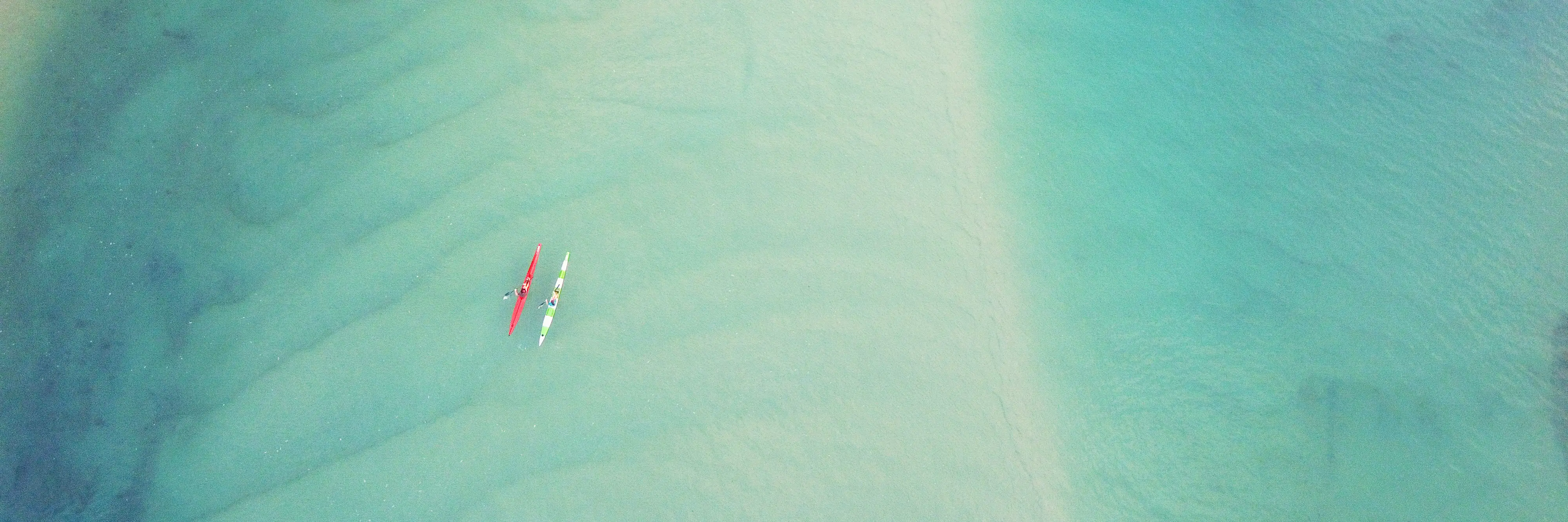 Aerial,Top,View,Of,Couple,People,Kayaking,Over,Blue,Creek