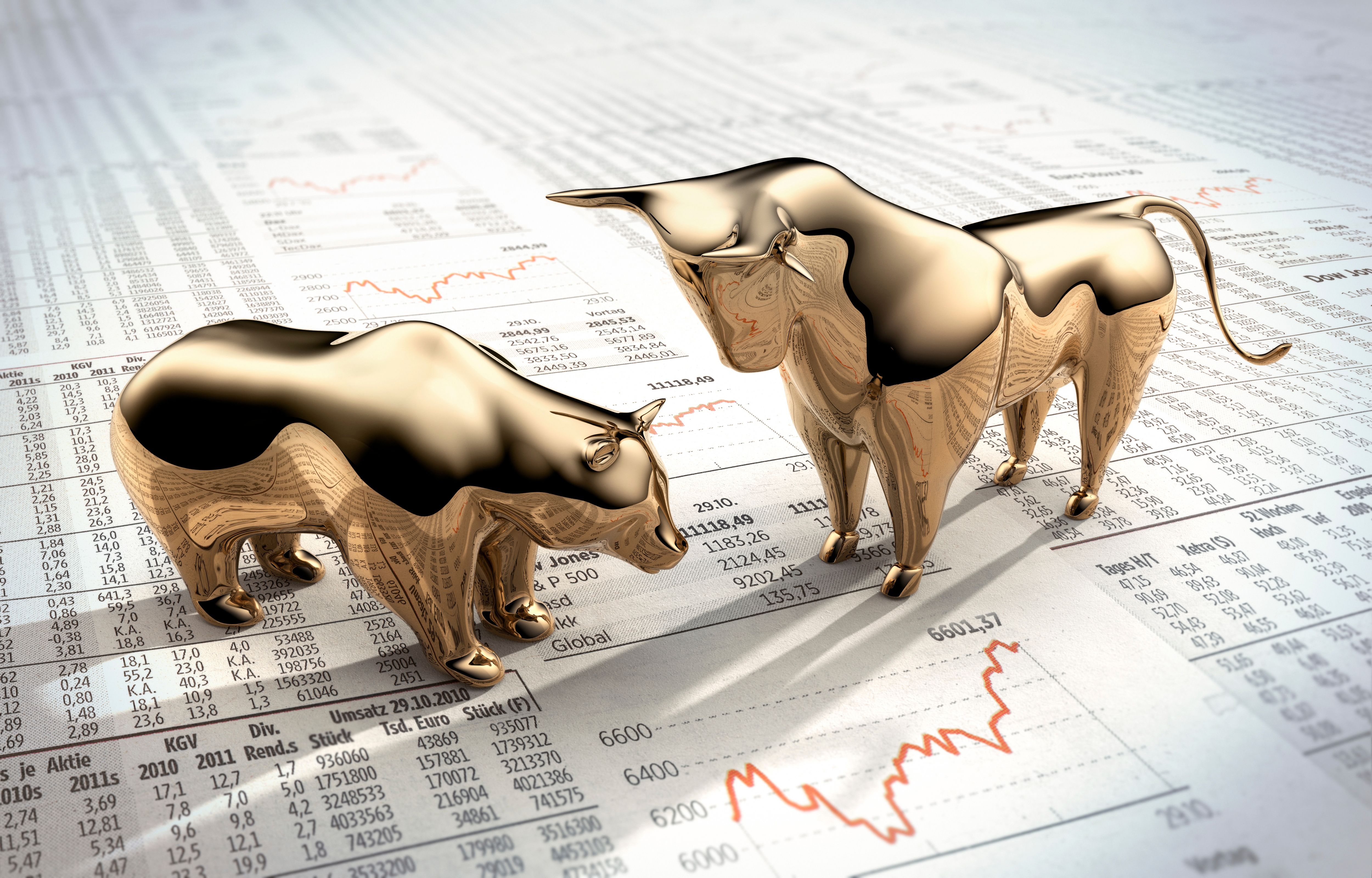 Golden bull and bear figures on financial data charts symbolizing stock market volatility, investor sentiment, and economic uncertainty in 2025.